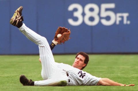 Paul O'Neill of the New York Yankees makes a sliding catch in right field for a fly ball hit by Don Slaught of the California Angels in the third inning 18 May at Yankee Stadium. Yankees won the game, 7-3. AFP PHOTO/Stan HONDA (Photo by STAN HONDA / AFP) (Photo by STAN HONDA/AFP via Getty Images)