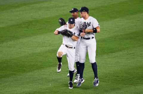 NEW YORK, NEW YORK - AUGUST 02: Aaron Judge #99, Aaron Hicks #31 and Brett Gardner #11 of the New York Yankees celebrate their 9-7 victory over Boston Red Sox of the New York Yankees at Yankee Stadium on August 02, 2020 in New York City. (Photo by Mike Stobe/Getty Images)