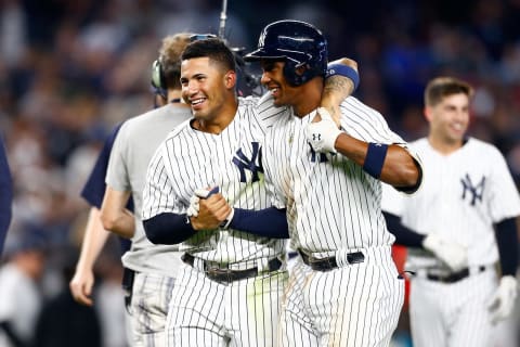 Miguel Andujar #41 and Gleyber Torres #25 of the New York Yankees celebrate after defeating the Baltimore Orioles in the eleventh inning on Aaron Hicks #31 walk-off RBI double at Yankee Stadium on September 22, 2018 in the Bronx borough of New York City. New York Yankees defeated the Baltimore Orioles 3-2 in eleventh inning. (Photo by Mike Stobe/Getty Images)