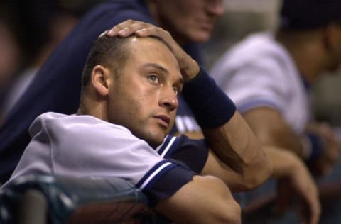 New York Yankees Derek Jeter looks up at the scoreboard in the ninth inning, 28 September 2000, as the Tampa Bay Devil Rays beat the Yankees 11-3 at Tropicana Field in St. Petersburg, Florida. AFP PHOTO/PETER MUHLY (Photo by PETER MUHLY / AFP) (Photo credit should read PETER MUHLY/AFP via Getty Images)