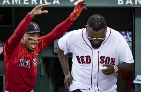 Mookie Betts #50 reacts as former designated hitter David Ortiz #34 of the Boston Red Sox is introduced before throwing out a ceremonial first pitch as he returns to Fenway Park before a game against the New York Yankees on September 9, 2019 at Fenway Park in Boston, Massachusetts. (Photo by Billie Weiss/Boston Red Sox/Getty Images)