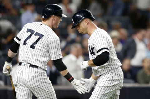 NEW YORK, NEW YORK - SEPTEMBER 19: (NEW YORK DAILIES OUT) Brett Gardner #11 and Clint Frazier #77 of the New York Yankees in action against the Los Angeles Angels of Anaheim at Yankee Stadium on September 19, 2019 in New York City. The Yankees defeated the Angels 9-1 to clinch the American League East division. (Photo by Jim McIsaac/Getty Images)