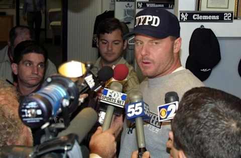 New York Yankees pitcher Roger Clemens (R facing camera) talks with the media after only his second loss of the season against the Tampa Bay Devil Rays 25 September 2001 at Yankee Stadium in New York, NY. Despite the 4-0 loss, the Yankees clinched the American League East for the fourth year in a row as a result of the Boston Red Sox's loss to the Baltimore Orioles at home. AFP PHOTO/Matt CAMPBELL (Photo by MATT CAMPBELL / AFP) (Photo by MATT CAMPBELL/AFP via Getty Images)