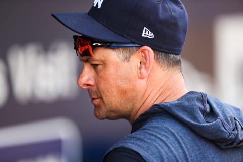 New York Yankees manager Aaron Boone #17 looks on from the dugout during the sixth inning of a spring training game against the Boston Red Sox at Steinbrenner Field on March 3, 2020 in Tampa, Florida. (Photo by Carmen Mandato/Getty Images)