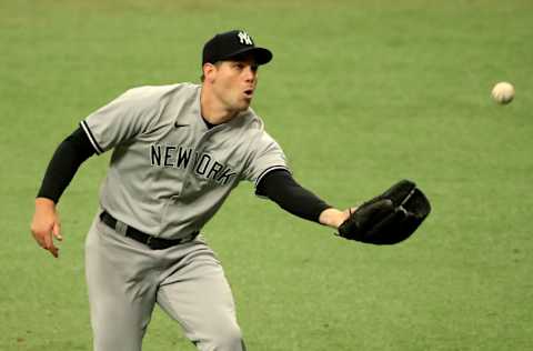 Adam Ottavino #0 of the New York Yankees fields a ground ball in the seventh inning during Game 1 of a doubleheader against the Tampa Bay Rays at Tropicana Field on August 08, 2020 in St Petersburg, Florida. (Photo by Mike Ehrmann/Getty Images)