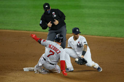 Christian Vazquez #7 of the Boston Red Sox slides in for a double as the ball get by Gleyber Torres #25 of the New York Yankees in the ninth inning at Yankee Stadium on August 16, 2020 in New York City. (Photo by Mike Stobe/Getty Images)