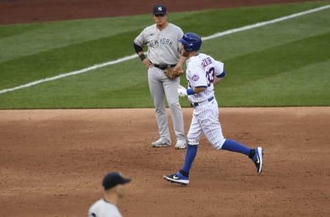 NEW YORK, NEW YORK - SEPTEMBER 03: Todd Frazier #33 of the New York Mets rounds the bases past Gio Urshela #29 of the New York Yankees after hitting a home run during the second inning at Citi Field on September 03, 2020 in the Queens borough of New York City. (Photo by Sarah Stier/Getty Images)