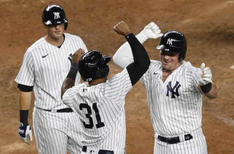 Luke Voit #59 of the New York Yankees celebrates with Aaron Hicks #31 and DJ LeMahieu #26 after Voit hitting a three-run home run during the sixth inning against the Toronto Blue Jays at Yankee Stadium on September 16, 2020 in the Bronx borough of New York City. (Photo by Sarah Stier/Getty Images)