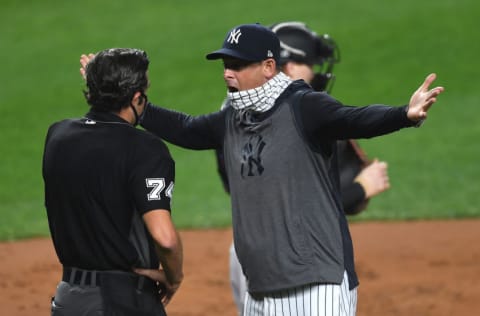 NEW YORK, NEW YORK - SEPTEMBER 25: Manager Aaron Boone #17 of the New York Yankees exchanges words with umpire John Tumpane #74 during the first inning against the Miami Marlins at Yankee Stadium on September 25, 2020 in the Bronx borough of New York City. (Photo by Sarah Stier/Getty Images)