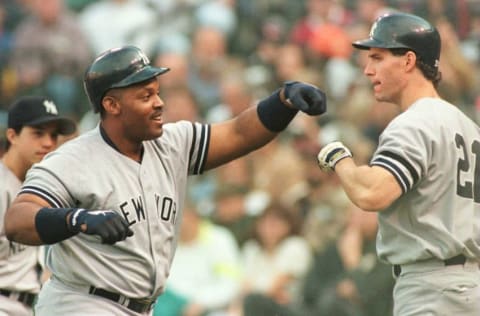 Cecil Fielder of the New York Yankees and teammate Paul O'Neill #21 celebrate after Fielder's three-run homerun during the third inning of game 5 of the American League Championship Series at Orioles Park, Camden Yards in Baltimore, Marylan