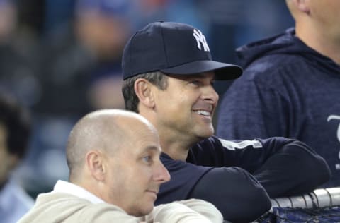 TORONTO, ON - MARCH 30: Manager Aaron Boone #17 of the New York Yankees and general manager Brian Cashman look on during batting practice before the start of MLB game action against the Toronto Blue Jays at Rogers Centre on March 30, 2018 in Toronto, Canada. (Photo by Tom Szczerbowski/Getty Images) *** Local Caption *** Aaron Boone;Brian Cashman