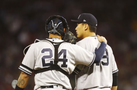 BOSTON, MASSACHUSETTS - SEPTEMBER 08: Catcher Gary Sanchez #24 of the New York Yankees visits Starting pitcher Masahiro Tanaka #19 of the New York Yankees on the mound in the bottom of the first inning of the game against the Boston Red Sox at Fenway Park on September 08, 2019 in Boston, Massachusetts. (Photo by Omar Rawlings/Getty Images)