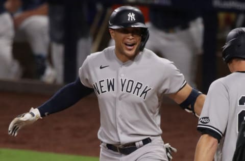 SAN DIEGO, CALIFORNIA - OCTOBER 05: Giancarlo Stanton #27 of the New York Yankees celebrates a grand slam home run against the New York Yankees during the ninth inning in Game One of the American League Division Series at PETCO Park on October 05, 2020 in San Diego, California. (Photo by Christian Petersen/Getty Images)