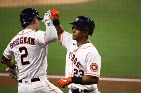 SAN DIEGO, CALIFORNIA - OCTOBER 13: Michael Brantley #23 of the Houston Astros celebrates a solo home run with teammate Alex Bregman #2 against the Tampa Bay Rays during the sixth inning in Game Three of the American League Championship Series at PETCO Park on October 13, 2020 in San Diego, California. (Photo by Ezra Shaw/Getty Images)