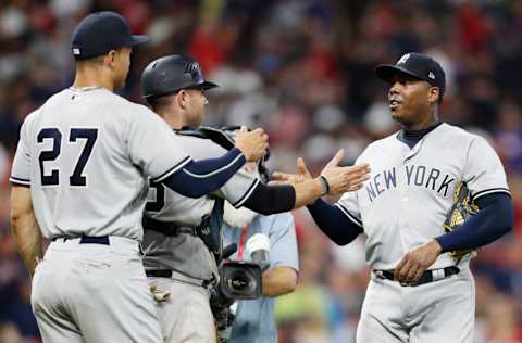 CLEVELAND, OH - JULY 14: Aroldis Chapman #54 of the New York Yankees is congratulated by teammates Austin Romine #28 and Giancarlo Stanton #27 at the conclusion of the game against the Cleveland Indians at Progressive Field on July 14, 2018 in Cleveland, Ohio. The Yankees defeated the Indians 5-4. (Photo by David Maxwell/Getty Images)