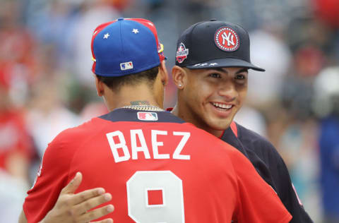 WASHINGTON, DC - JULY 16: Gleyber Torres #25 of the New York Yankees and the American League hugs Javier Baez #9 of the Chicago Cubs and the National League during Gatorade All-Star Workout Day at Nationals Park on July 16, 2018 in Washington, DC. (Photo by Rob Carr/Getty Images)