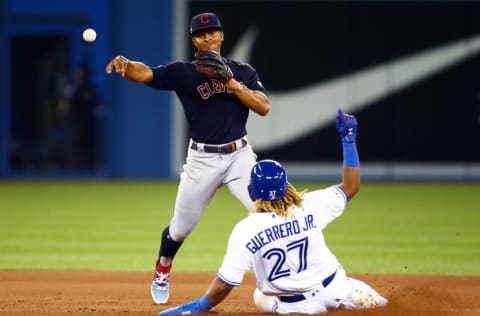 TORONTO, ON - JULY 22: Vladimir Guerrero Jr. #27 of the Toronto Blue Jays is forced out at second base by Francisco Lindor #12 of the Cleveland Indians in the seventh inning during a MLB game at Rogers Centre on July 22, 2019 in Toronto, Canada. (Photo by Vaughn Ridley/Getty Images)