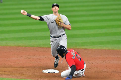 CLEVELAND, OHIO - SEPTEMBER 30: Delino DeShields #0 of the Cleveland Indians is forced out at second as second baseman DJ LeMahieu #26 of the New York Yankees throws to first for a double play on a ground ball hit by Francisco Lindor #12 to end the sixth inning of Game Two of the American League Wild Card Series at Progressive Field on September 30, 2020 in Cleveland, Ohio. The Yankees defeated the Indians 10-9. (Photo by Jason Miller/Getty Images)