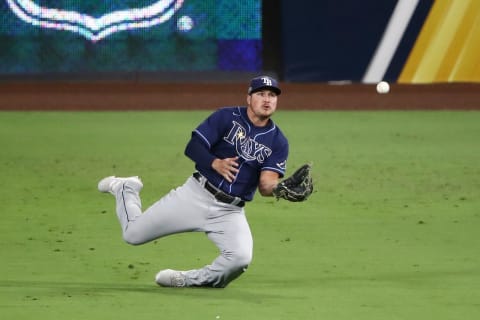 SAN DIEGO, CALIFORNIA – OCTOBER 13: Hunter Renfroe #11 of the Tampa Bay Rays makes a diving catch to out Kyle Tucker #30 of the Houston Astros during the eighth inning in Game Three of the American League Championship Series at PETCO Park on October 13, 2020 in San Diego, California. (Photo by Ezra Shaw/Getty Images)