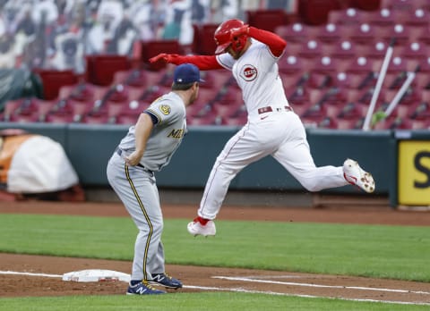 CINCINNATI, OH – SEPTEMBER 22: Jedd Gyorko #5 of the Milwaukee Brewers reaches to tag out Nick Senzel #15 of the Cincinnati Reds during the game at Great American Ball Park on September 22, 2020 in Cincinnati, Ohio. (Photo by Michael Hickey/Getty Images)