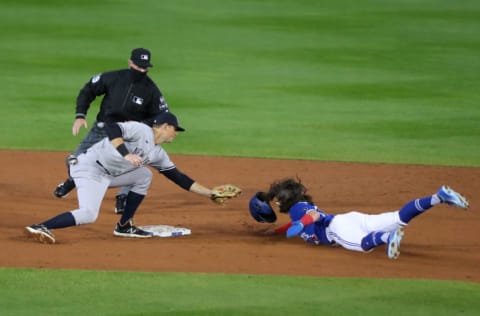 BUFFALO, NY - SEPTEMBER 23: DJ LeMahieu #26 of the New York Yankees tags out Bo Bichette #11 of the Toronto Blue Jays as he tries to steal second base at Sahlen Field on September 23, 2020 in Buffalo, New York. The Blue Jays are the home team due to the Canadian government's policy on COVID-19, which prevents them from playing in their home stadium in Canada. (Photo by Timothy T Ludwig/Getty Images)