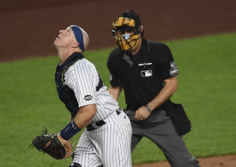 NEW YORK, NEW YORK – AUGUST 28: Erik Kratz #42 of the New York Yankees looks on during the second inning of the second game of a doubleheader against the New York Mets at Yankee Stadium on August 28, 2020 in the Bronx borough of New York City. All players are wearing #42 in honor of Jackie Robinson Day. The day honoring Jackie Robinson, traditionally held on April 15, was rescheduled due to the COVID-19 pandemic. (Photo by Sarah Stier/Getty Images)