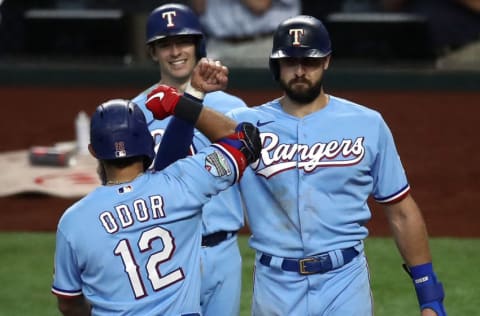 ARLINGTON, TEXAS - SEPTEMBER 27: Rougned Odor #12 of the Texas Rangers celebrates a three-run home run with Joey Gallo #13 and Nick Solak #15 against the Houston Astros in the fourth inning at Globe Life Field on September 27, 2020 in Arlington, Texas. (Photo by Ronald Martinez/Getty Images)