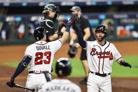 HOUSTON, TEXAS – OCTOBER 07: Dansby Swanson #7 of the Atlanta Braves celebrates his homerun with teammate Adam Duvall #23 during the second inning against the Miami Marlins in Game Two of the National League Division Series at Minute Maid Park on October 07, 2020 in Houston, Texas. (Photo by Elsa/Getty Images)