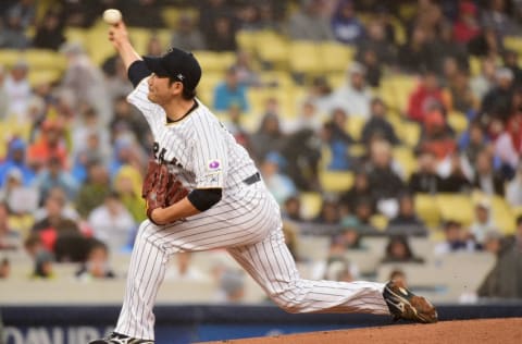 LOS ANGELES, CA - MARCH 21: Tomoyuki Sugano #11 of the Japan pitches in the first inning against team United States during Game 2 of the Championship Round of the 2017 World Baseball Classic at Dodger Stadium on March 21, 2017 in Los Angeles, California. (Photo by Harry How/Getty Images)