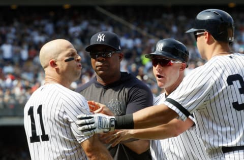 NEW YORK, NY - AUGUST 17: Brett Gardner #11 of the New York Yankees is held back by Marcus Thames #62, Reggie Willits #50 and Mike Tauchman #39 of the New York Yankees as he argues with the umpire Todd Tichenor after Gardner was ejected for banging a bat on the dugout roof complaining about the umpiring in an MLB baseball game against the Cleveland Indians at Yankee Stadium in the Bronx borough of New York City on August 17, 2019. Yankees won 6-5. (Photo by Paul Bereswill/Getty Images)