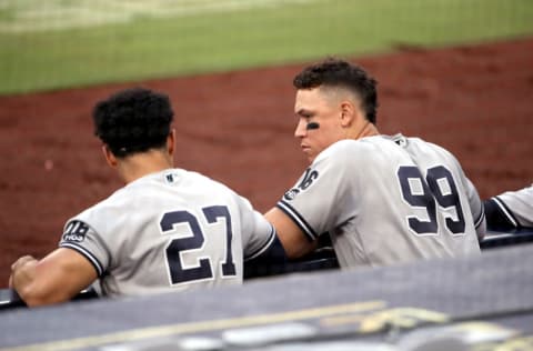 SAN DIEGO, CALIFORNIA - OCTOBER 09: Giancarlo Stanton #27 and Aaron Judge #99 of the New York Yankees talk in the dugout during the fifth inning against the Tampa Bay Rays in Game Five of the American League Division Series at PETCO Park on October 09, 2020 in San Diego, California. (Photo by Christian Petersen/Getty Images)