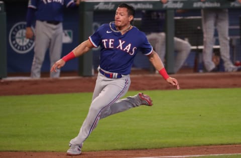 SEATTLE, WASHINGTON - SEPTEMBER 06: Derek Dietrich #32 runs home off a double by Leody Taveras #65 of the Texas Rangers only to be tagged out by Joseph Odom #54 of the Seattle Mariners to end the seventh inning at T-Mobile Park on September 06, 2020 in Seattle, Washington. (Photo by Abbie Parr/Getty Images)