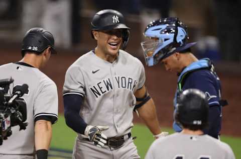 SAN DIEGO, CALIFORNIA - OCTOBER 05: Giancarlo Stanton #27 of the New York Yankees celebrates a grand slam home run as Michael Perez #7 of the Tampa Bay Rays hangs his head during the ninth inning in Game One of the American League Division Series at PETCO Park on October 05, 2020 in San Diego, California. (Photo by Christian Petersen/Getty Images)