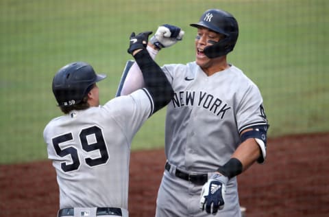 SAN DIEGO, CALIFORNIA - OCTOBER 09: Aaron Judge #99 of the New York Yankees is congratulated by Luke Voit #59 after hitting a solo home run against the Tampa Bay Rays during the fourth inning in Game Five of the American League Division Series at PETCO Park on October 09, 2020 in San Diego, California. (Photo by Christian Petersen/Getty Images)