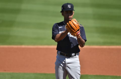 CLEARWATER, FLORIDA - MARCH 04: Deivi García #83 of the New York Yankees delivers a pitch against the Philadelphia Phillies in a spring training game at BayCare Ballpark on March 04, 2021 in Clearwater, Florida. (Photo by Mark Brown/Getty Images)