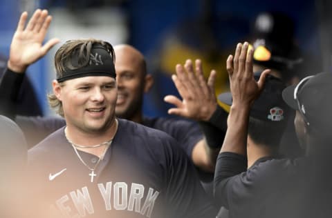 DUNEDIN, FLORIDA - MARCH 21: Luke Voit #59 of the New York Yankees celebrates with teammates after scoring during the first inning against the Toronto Blue Jays during a spring training game at TD Ballpark on March 21, 2021 in Dunedin, Florida. (Photo by Douglas P. DeFelice/Getty Images)