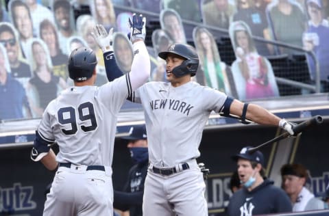 SAN DIEGO, CALIFORNIA - OCTOBER 09: Aaron Judge #99 of the New York Yankees is congratulated by Giancarlo Stanton #27 after hitting a solo home run against the Tampa Bay Rays during the fourth inning in Game Five of the American League Division Series at PETCO Park on October 09, 2020 in San Diego, California. (Photo by Sean M. Haffey/Getty Images)