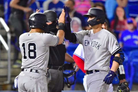 Rougned Odor #18 celebrates with Kyle Higashioka #66 of the New York Yankees (Photo by Julio Aguilar/Getty Images)