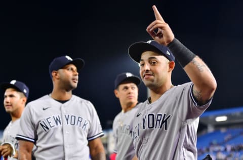 DUNEDIN, FLORIDA - APRIL 12: Rougned Odor #18 of the New York Yankees gestures to fans while walking off the field with Aaron Hicks #31 and Gio Urshela #29 of the New York Yankees following a 3-1 win over the Toronto Blue Jays at TD Ballpark on April 12, 2021 in Dunedin, Florida. (Photo by Julio Aguilar/Getty Images)