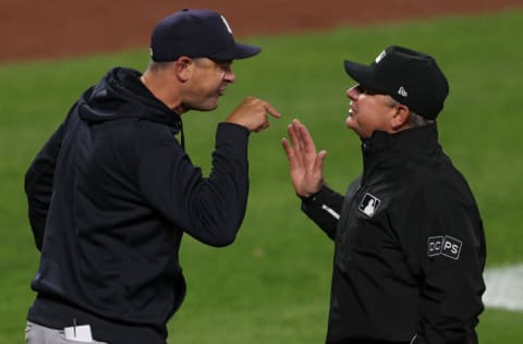 BALTIMORE, MARYLAND - APRIL 26: Manager Aaron Boone of the New York Yankees (L) argues with umpire Greg Gibson #53 after being ejected from the ballgame during the eighth inning against the Baltimore Orioles at Oriole Park at Camden Yards on April 26, 2021 in Baltimore, Maryland. (Photo by Patrick Smith/Getty Images)