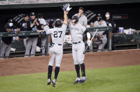 BALTIMORE, MARYLAND - APRIL 27: Giancarlo Stanton #27 of the New York Yankees celebrates with Aaron Judge #99 after hitting a home run in the seventh inning against the Baltimore Orioles at Oriole Park at Camden Yards on April 27, 2021 in Baltimore, Maryland. (Photo by Greg Fiume/Getty Images)