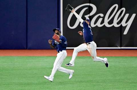 ST PETERSBURG, FLORIDA - APRIL 27: Kevin Kiermaier #39 of the Tampa Bay Rays catches a fly ball over the head of Yandy Diaz #2 during the sixth inning against the Oakland Athletics at Tropicana Field on April 27, 2021 in St Petersburg, Florida. (Photo by Douglas P. DeFelice/Getty Images)