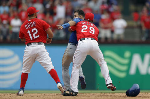 ARLINGTON, TX - MAY 15: Adrian Beltre #29 of the Texas Rangers holds Jose Bautista #19 of the Toronto Blue Jays after being punched by Rougned Odor #12 in the eighth inning at Globe Life Park in Arlington on May 15, 2016 in Arlington, Texas. (Photo by Ronald Martinez/Getty Images)