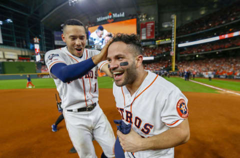 HOUSTON, TEXAS - OCTOBER 19: Jose Altuve #27 of the Houston Astros is congratulated by his teammate Carlos Correa #1 following his ninth inning walk-off two-run home run to defeat the New York Yankees 6-4 in game six of the American League Championship Series at Minute Maid Park on October 19, 2019 in Houston, Texas. The Astros defeated the Yankees 6-4. (Photo by Elsa/Getty Images)