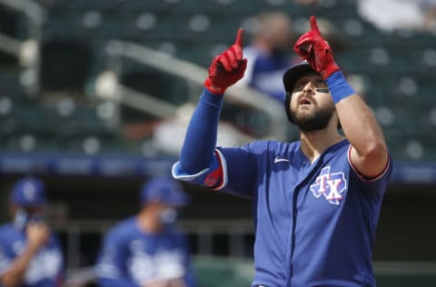 SURPRISE, ARIZONA - MARCH 07: Joey Gallo #13 of the Texas Rangers gestures skyward as he crosses the plate after hitting a home run against the Los Angeles Dodgers during the first inning of the MLB spring training baseball game at Surprise Stadium on March 07, 2021 in Surprise, Arizona. (Photo by Ralph Freso/Getty Images)