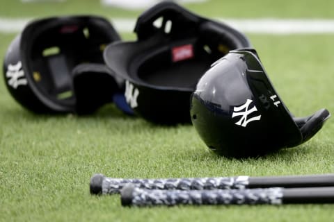 General view of the glove and hat of bats and helmets of the Yankees (Photo by Douglas P. DeFelice/Getty Images)