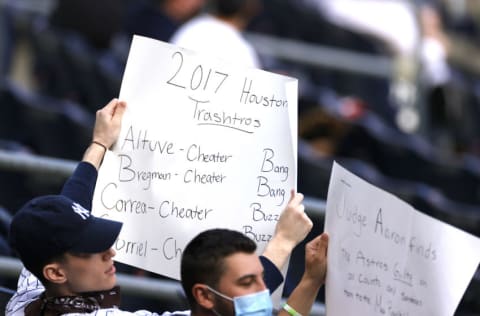 NEW YORK, NEW YORK - MAY 04: New York Yankees fans hold signs during the first inning against the Houston Astros at Yankee Stadium on May 04, 2021 in the Bronx borough of New York City. (Photo by Sarah Stier/Getty Images)