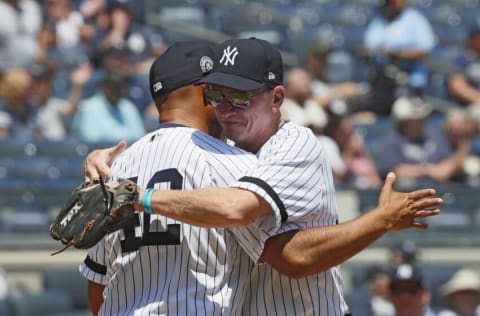 NEW YORK, NY - JUNE 23: Former Yankees pitcher Mariano Rivera, who will be inducted into the Baseball Hall of Fame this year, gets a hug from Old Timer David Cone during Old Timer's Day festivities before an MLB baseball game between the New York Yankees and Houston Astros on June 23, 2019 at Yankee Stadium in the Bronx borough of New York City. (Photo by Paul Bereswill/Getty Images)