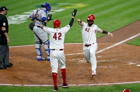 CINCINNATI, OH - AUGUST 28: Nicholas Castellanos #42 of the Cincinnati Reds congratulates Jesse Winker #42 after scoring a run during the fifth inning of the game against the Chicago Cubs at Great American Ball Park on August 28, 2020 in Cincinnati, Ohio. All players are wearing #42 in honor of Jackie Robinson Day. The day honoring Jackie Robinson, traditionally held on April 15, was rescheduled due to the COVID-19 pandemic. (Photo by Kirk Irwin/Getty Images)