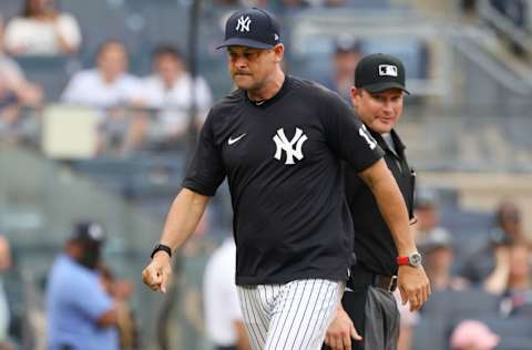 NEW YORK, NY - JUNE 19: Manager Aaron Boone #17 of the New York Yankees walks off the field after being ejected by home plate umpire Sean Barber #29 during ninth inning of a game against the Oakland Athletics at Yankee Stadium on June 19, 2021 in New York City. The Yankees defeated the As 7-5. (Photo by Rich Schultz/Getty Images)